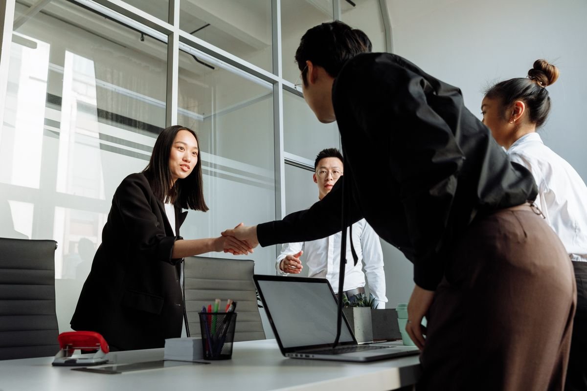 b2b tech - team handshake in office meeting